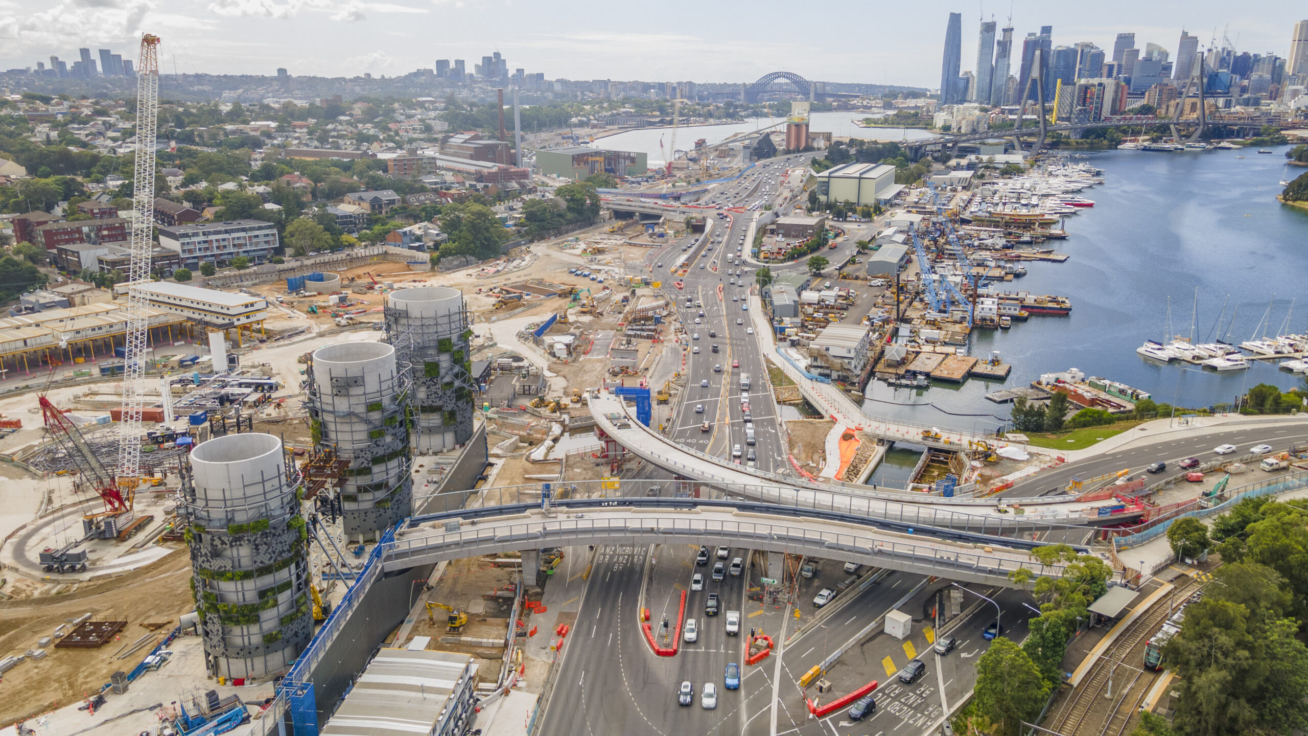 Aerial drone view of Rozelle Interchange showing major construction works and the large chimney towers with Anzac Bridge