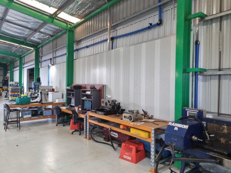 Workbenches in front of a Sonic System acoustic modular panel wall lining