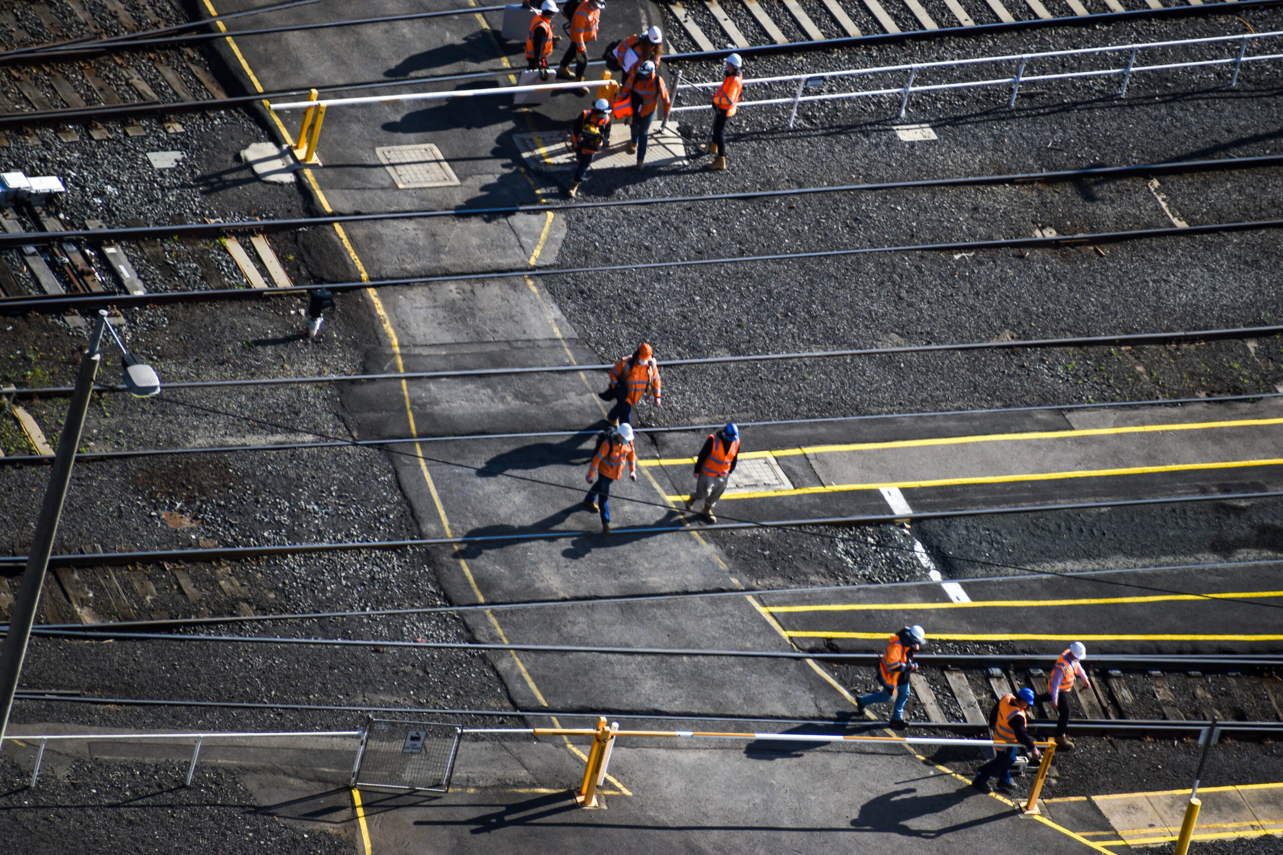southern Cross station in Melbourne, Victoria, Australia. They are crossing the railway tracks to go to construction site.