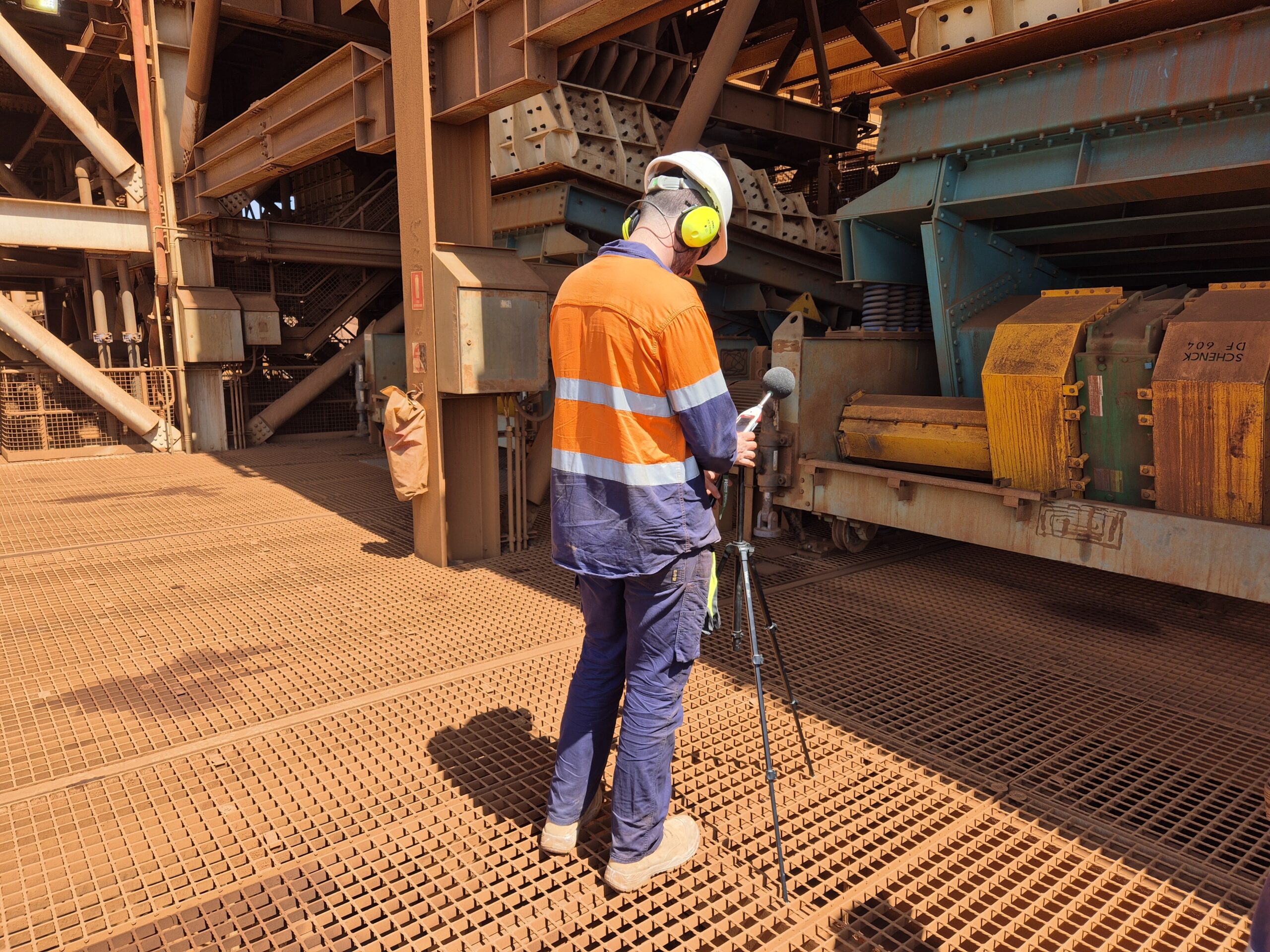 Employee performing acoustic testing on noise mining equipment