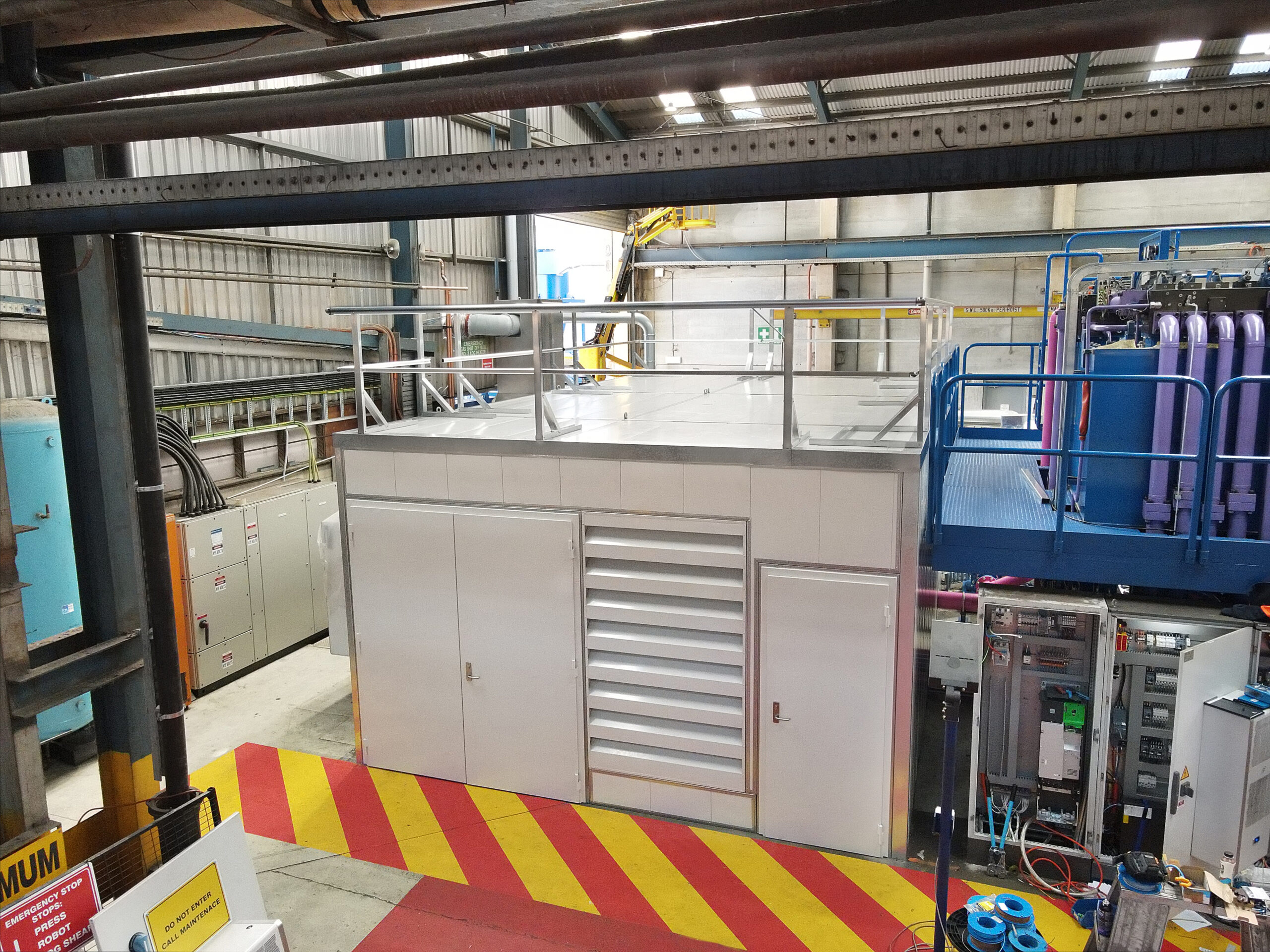 AcousTech Sonic Acoustic Enclosure enclosing noisy equipment in a manufacturing facility
