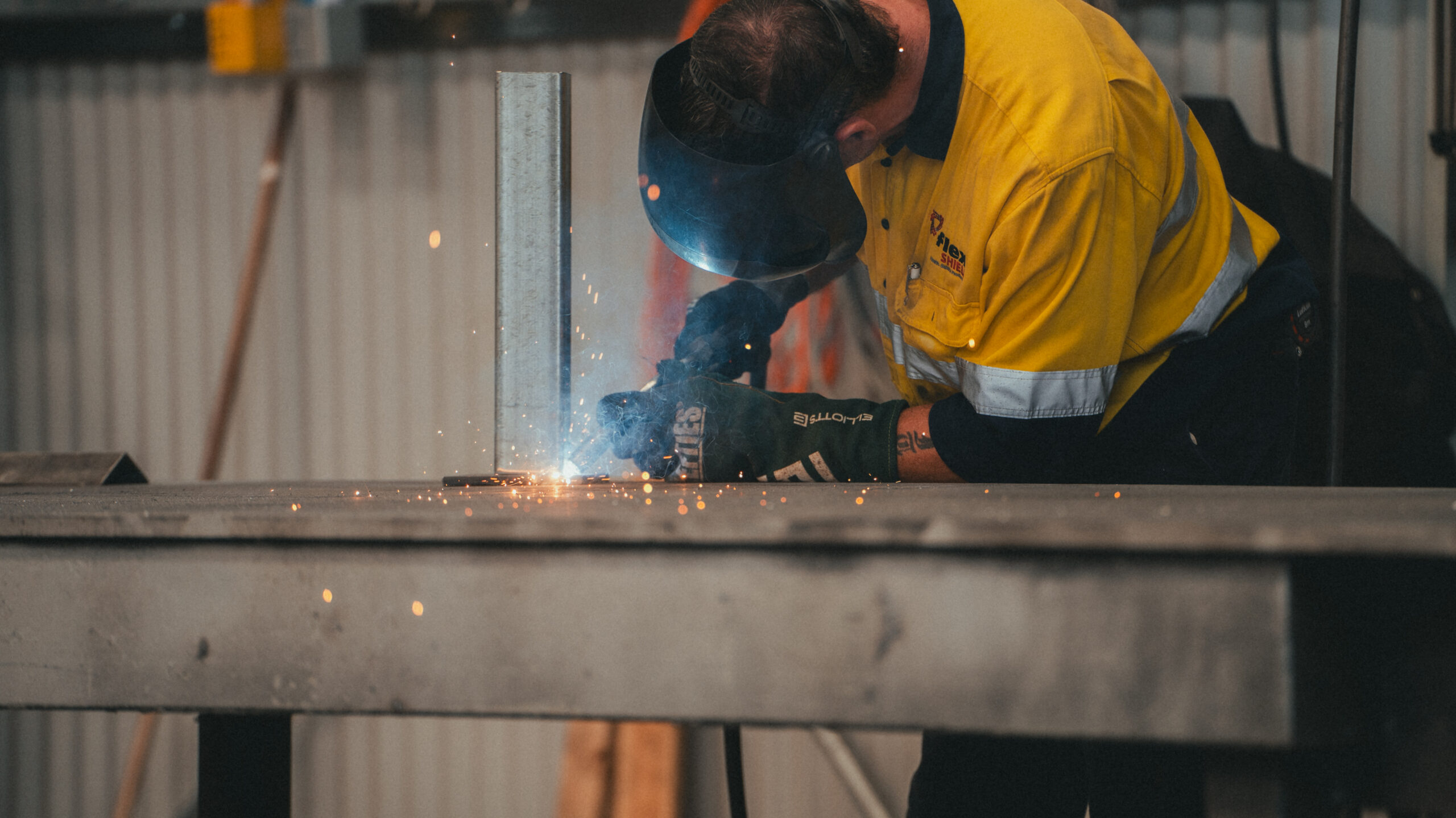 AcousTech employee welding a noise control solution