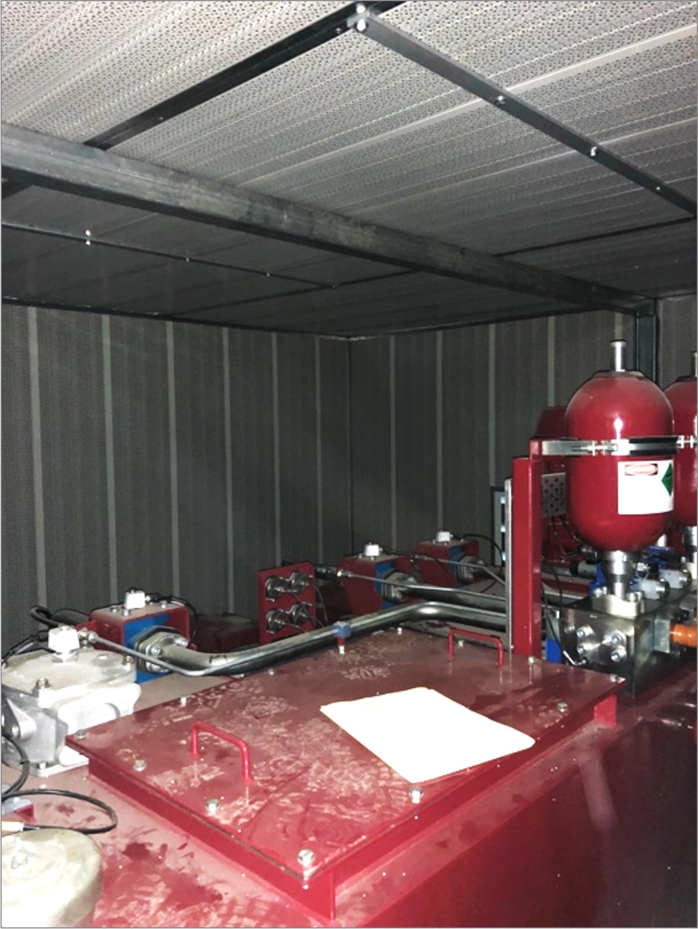 The inside of an acoustic enclosure surrounding rail equipment