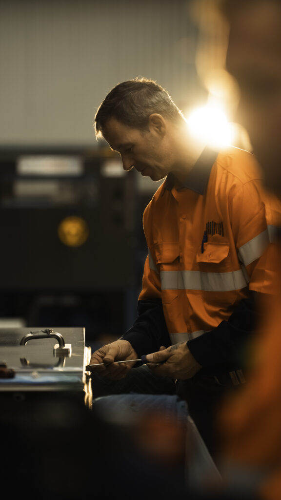 AcousTech factory worker installing an acoustic door handle